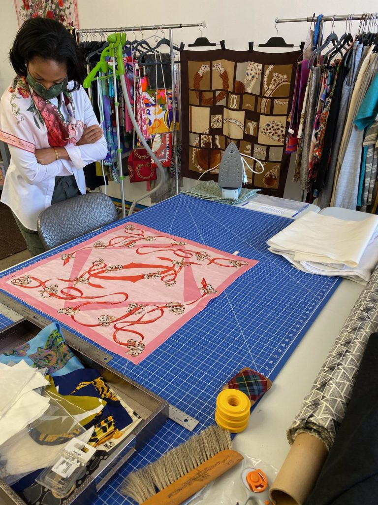 The Cartier scarf is on the cutting board at RoKi Design, destined to become a mask or brooch or even a scrunchie.