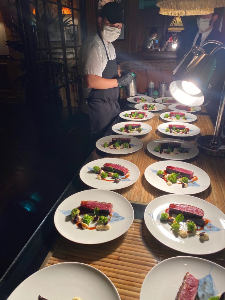 Le Colonia executive chef Hassan Obaye in mask and gloves throughout his preparation of each dish for the Caymus winer dinner at Le Colonial.
