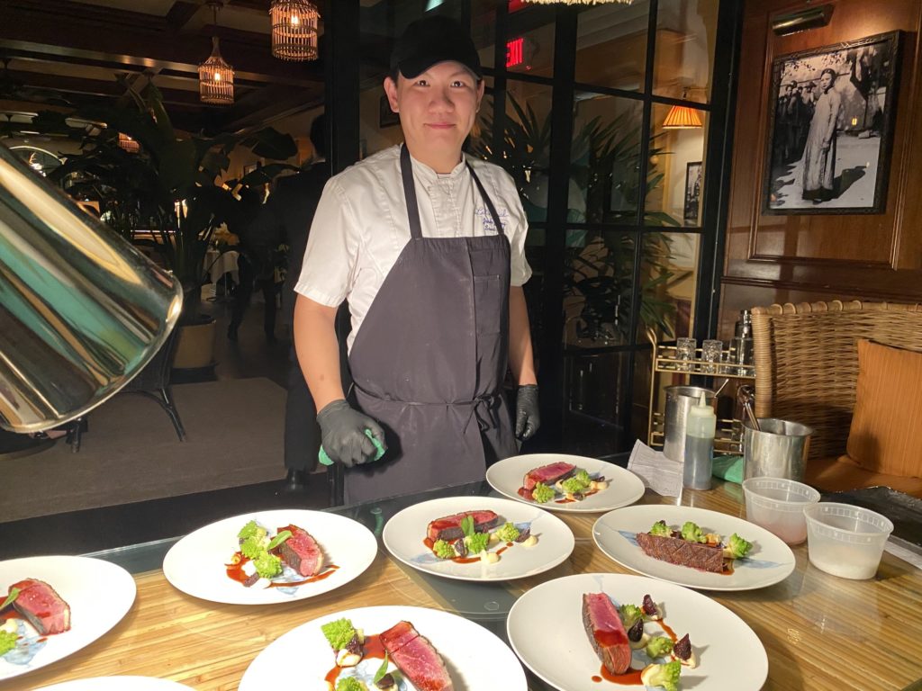 Le Colonial executive chef Hassan Obaye, mask removed for the photo only,  prepares a five-course feast for  guests attending the Caymus wine dinner. 