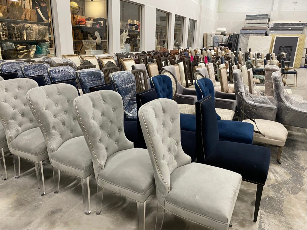 Dining table chairs come in all varieties in real estate agent David B. Atkins' warehouse where he stores furniture for staging. (Photo by Shelby Hodge)