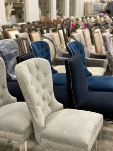An ocean of dining chairs takes over part of the home staging warehouse of real estate agent David B. Atkins.