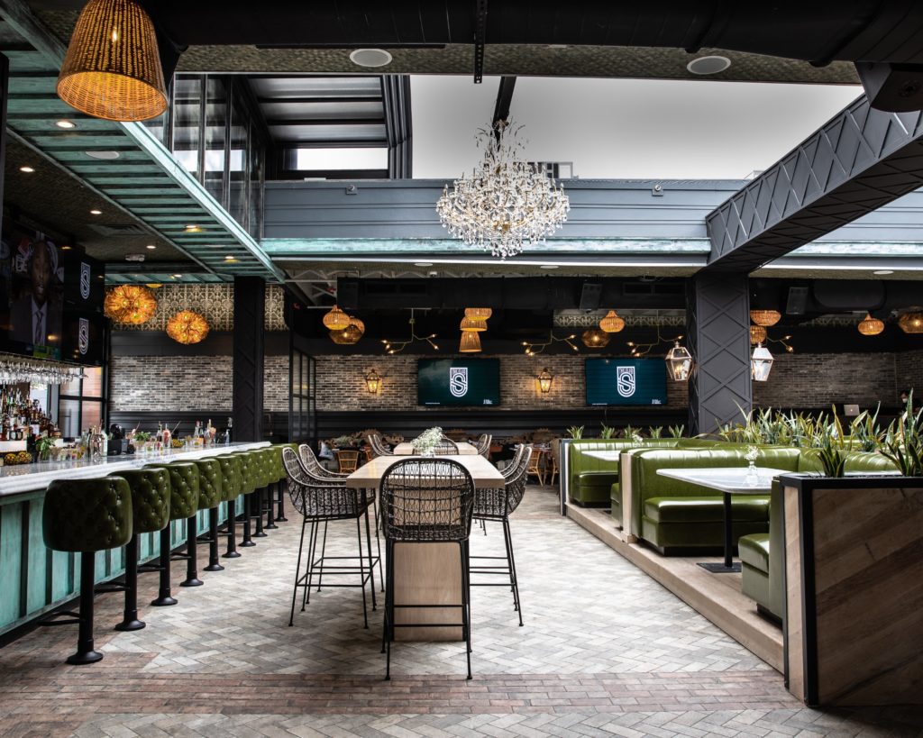 The sleek space of The Sporting Club, retractible roof open, was created by CBD Architects, based in Chicago. (Photo by Corine Michel )