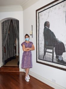 Liliana Bloch with a Letitia Huckaby painting, "Sister Rebecca" (Photo by Jonathan Zizzo)