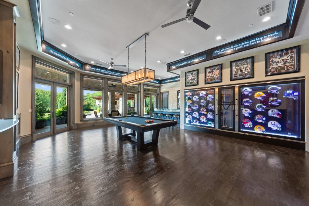 The game room where the collection of signed football helmets can be yours for an additional price.
