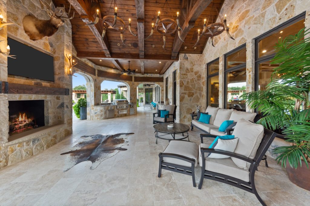 The patio off of the main living area is climate controlled, has retractable screens, a fireplace, TV and outdoor kitchen with Wolf appliances.