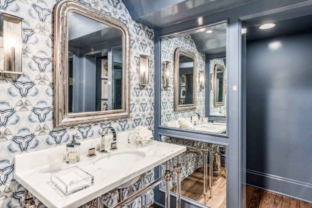 Farnham – powder room with custom nickel and Lucite based marble sink and inlaid stone wall. That’s not wallpaper.