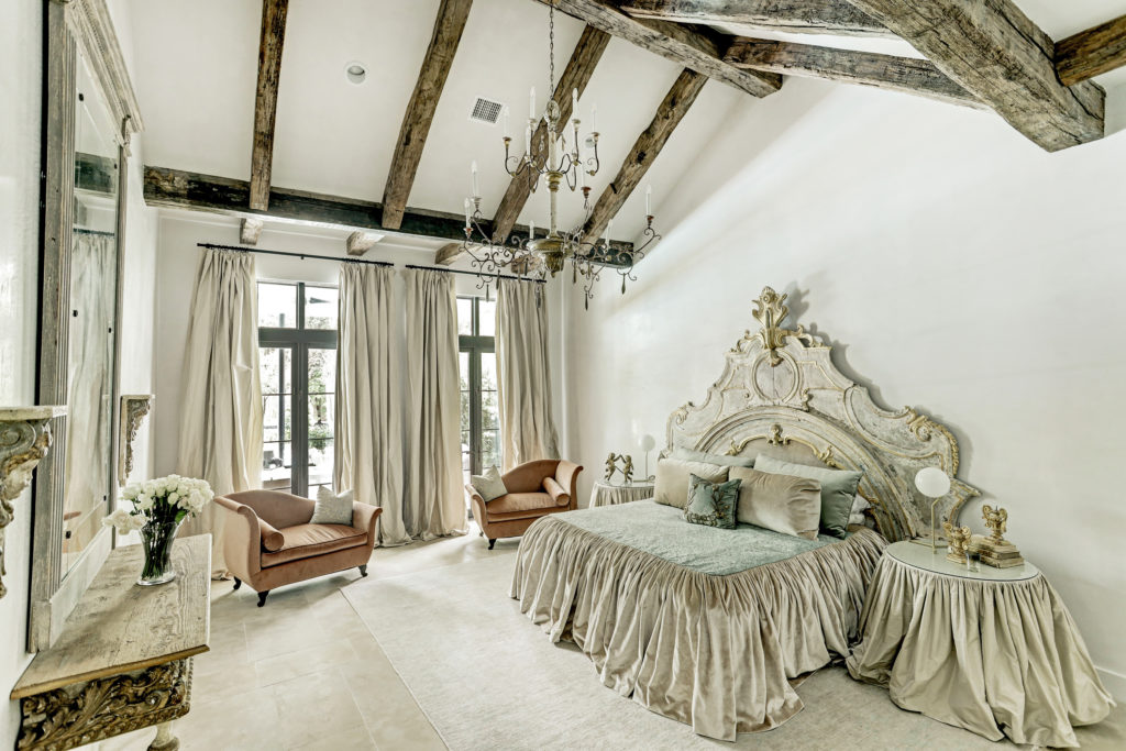  Reclaimed wood beams and an 18th century Italian chandelier highlight the vaulted ceiling of the master suite at 722 E. Friar Tuck Lane.