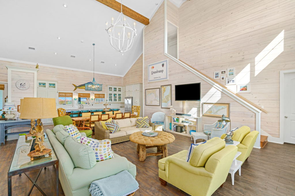 Design features include vaulted ceiling in the living and dining areas where whitewashed shiplap walls give a nod to the beachfront location.