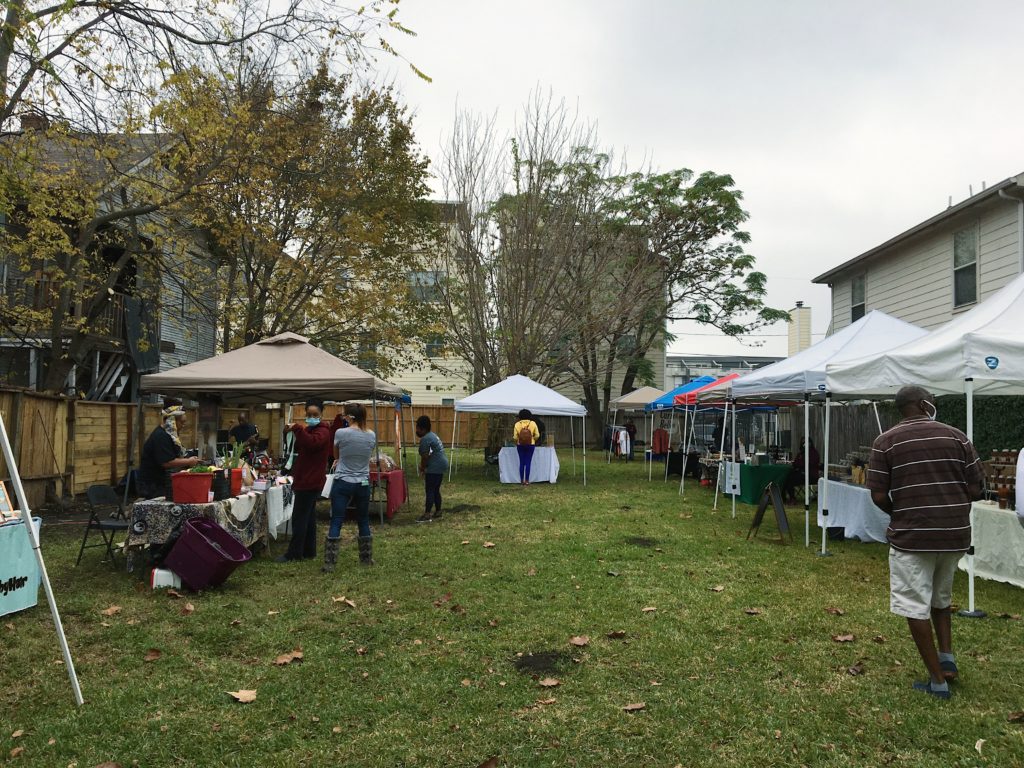A grassy lot in between houses in Freedmen's Town hosts a a new weekly farmers market.