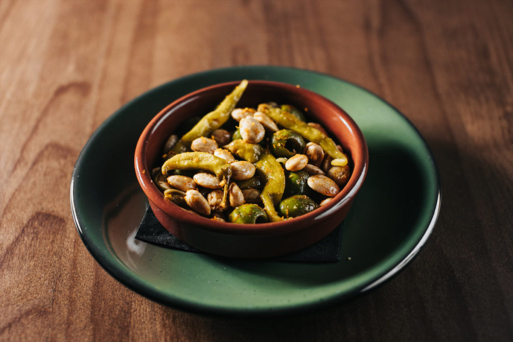 Snack on almonds, olives, and peppers with your cocktail at Ounce. (Photo by Kathy Tran)