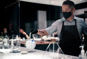 Chef Billy Kin pours tea at Hidden Omakase