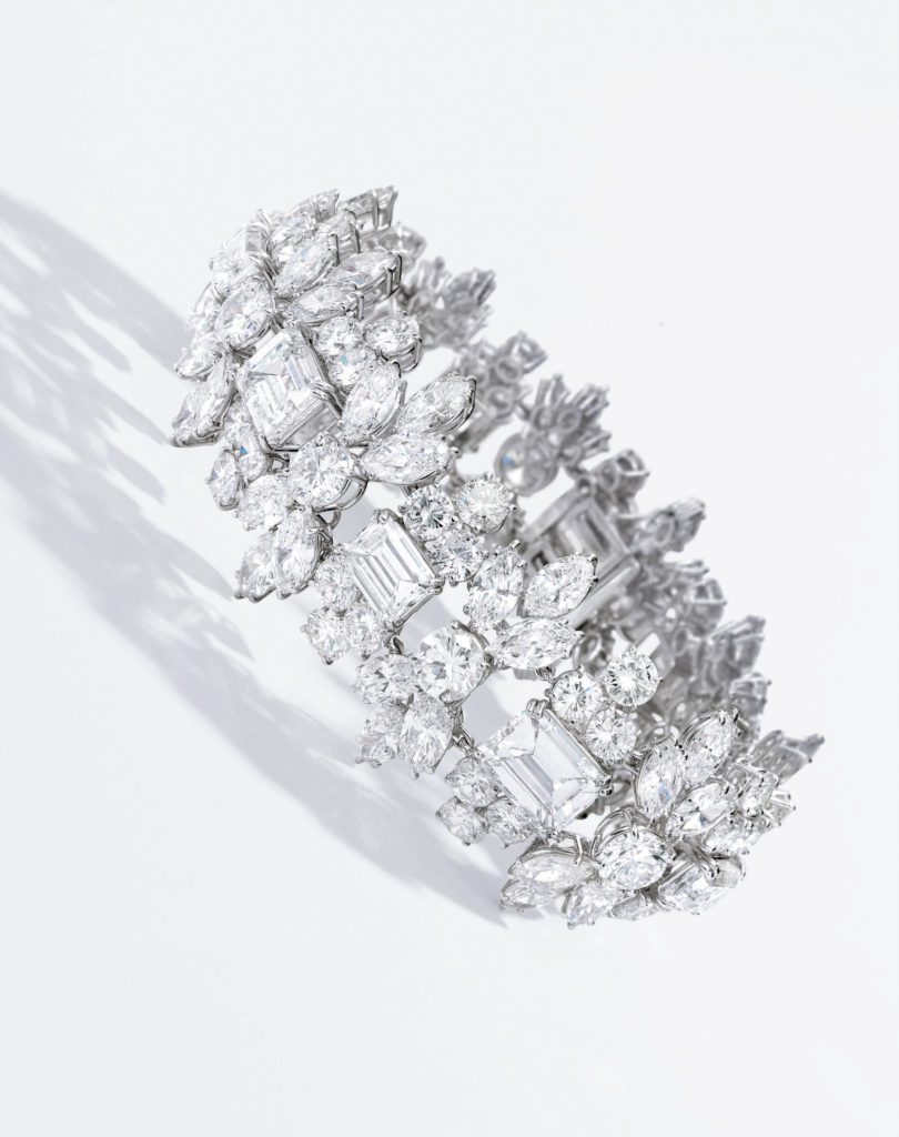<b>Diamond Bracelet, David Webb</b>
Set with ten emerald-cut diamonds alternating with ten round diamonds, embellished with round and marquise-shaped diamonds, length 7¼ inches, signed Webb; circa 1960s. With signed box.
Estimate $200/300,000
