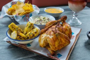 Rotisserie chicken with chipotle smashed potatoes and roasted corn on the cob at Valencia’s Tex-Mex Garage
