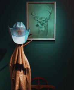 Johns Adams and Chantelle Adams journeyed around Houston and found a 50’s old Lamé cowboy jacket and a ruby red antique sled for the “Hard Candy Christmas” installation. (Photo by Marcus Pontello)