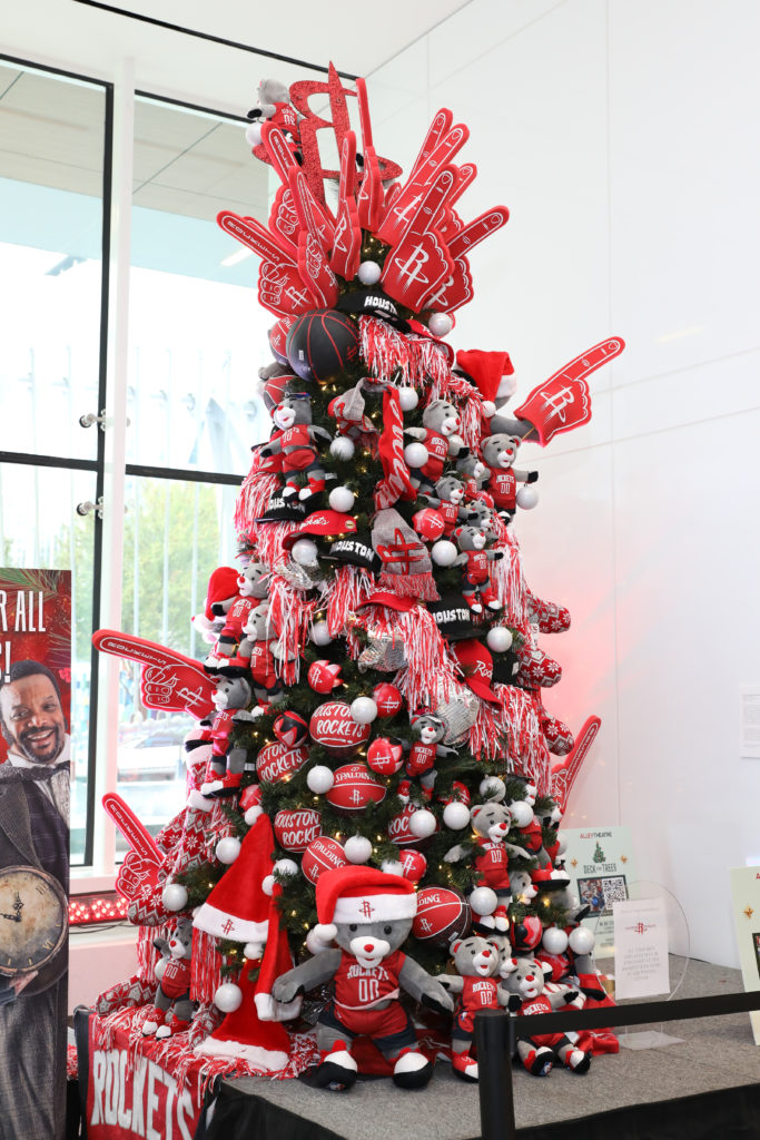 The Alley Theatre Deck the Trees display of decorated conifers. The One Mission — Houston Rockets tree by The Events Company.