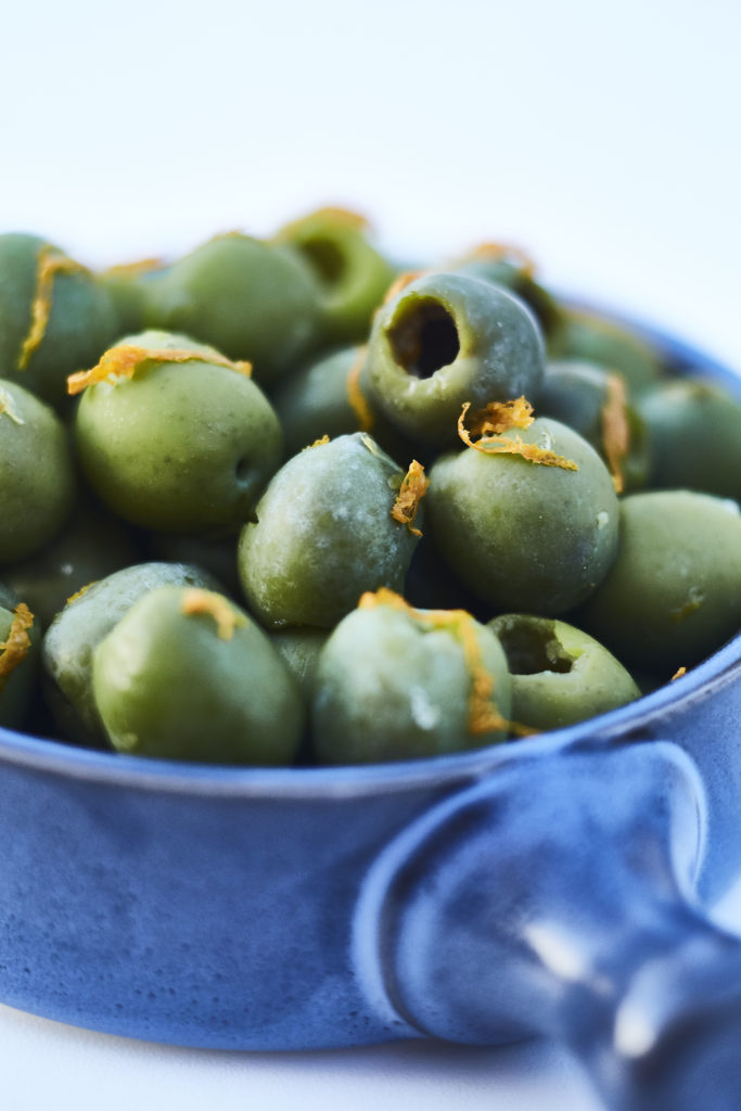 Snack on warm olives, poblano dip, and more with drinks at Catbird. (Photo by Gustav Schmiege)