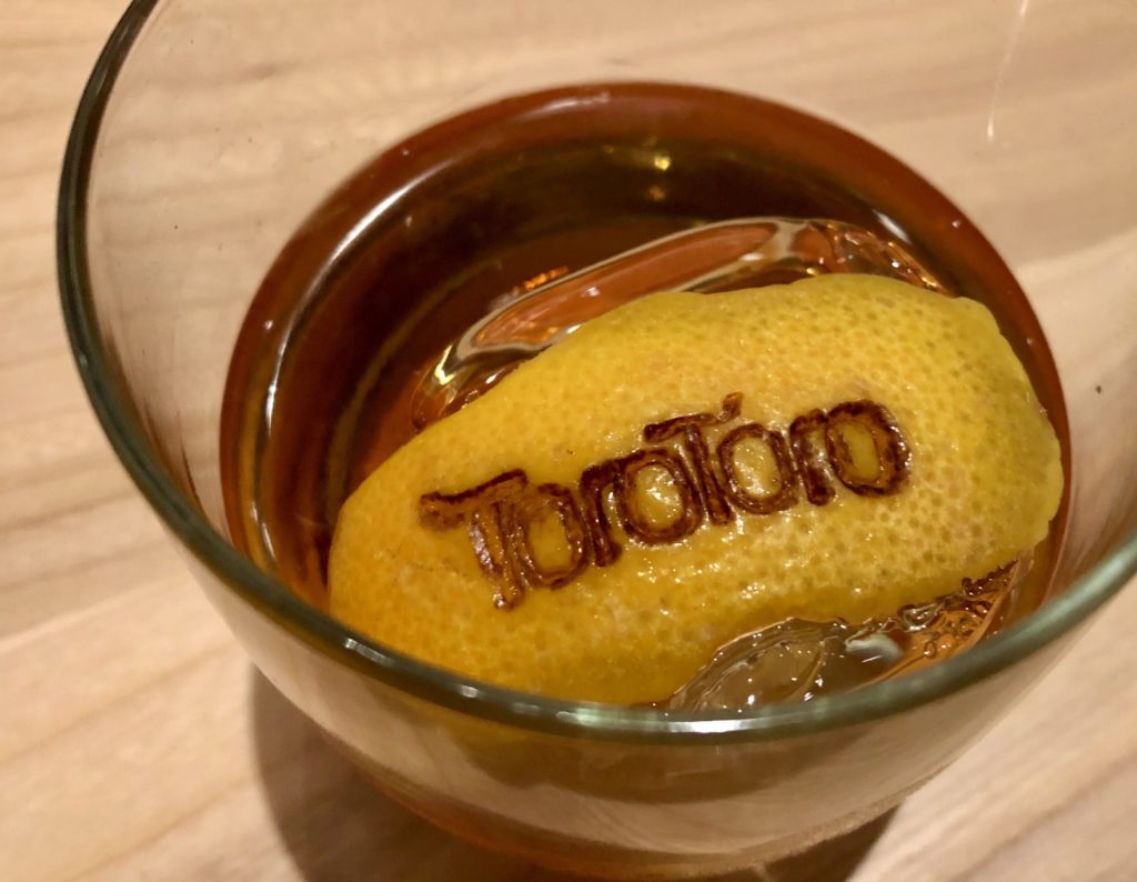 Toro Toro's Manhattan with branded orange peel. Photo by Courtney Dabney.