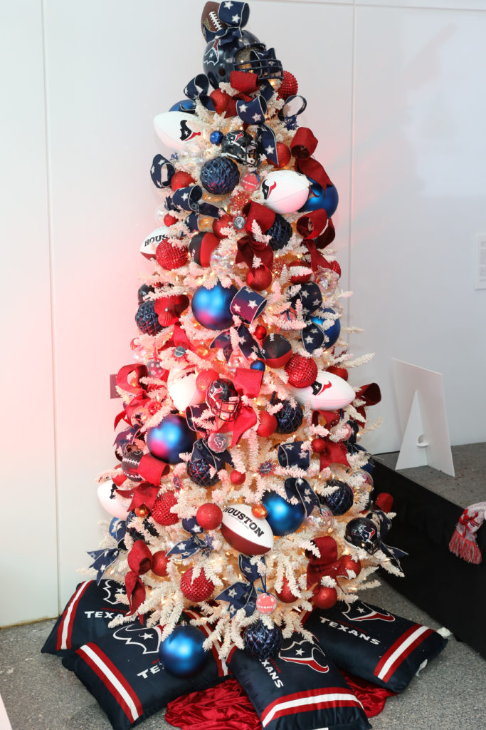 The Alley Theatre Deck the Trees display of decorated conifers. The We Are Texans Tree sponsored by the Houston Texans and designed by Taylor DeMartino.