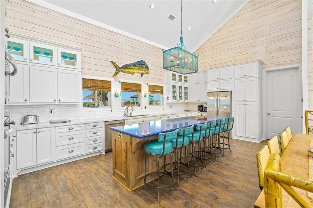 The cobalt blue Silestone island is focus of kitchen activity in this vacation home.