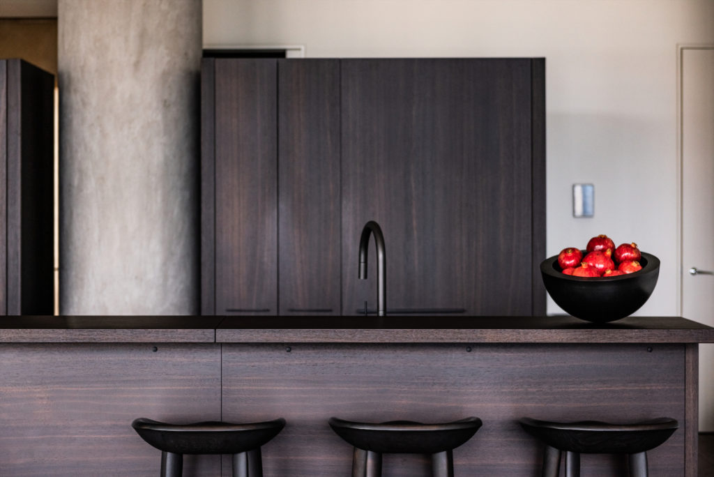 Custom Poliform kitchen from Scott + Cooner. John Pawson bronze bowl. Barstools by BassamFellows. (Photo by Robert Yu)