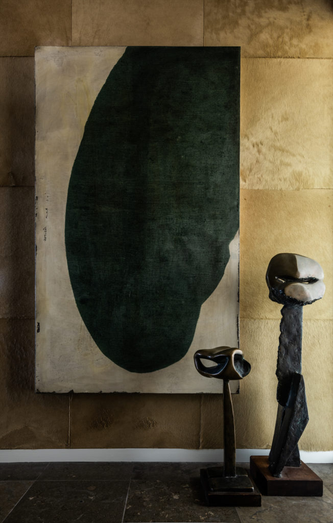 The entry vestibule's walls are covered in hide panels. Painting by Antonio Murado from Holly Johnson Gallery. Mid-20th-century bronze sculptures from Sputnik Modern. (Photo by Robert Yu)
