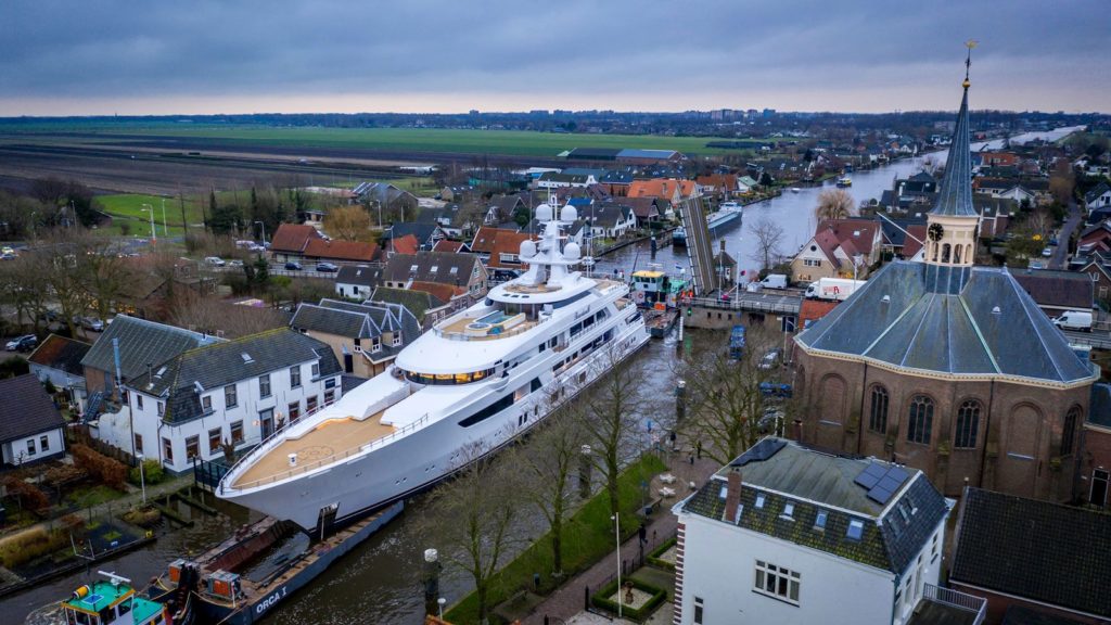 Tilman Fertitta's 252-foot, $150 million super yacht 'Boardwalk' courses through canals after departing Feadship's Aalsmeer shipyard in The Netherlands on its way to sea trials. (Photo courtesy of Feadship)