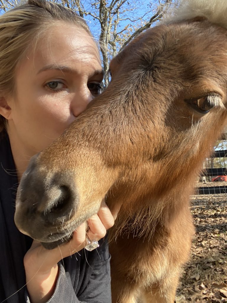 Frances Moody shares the love with rescued mini-horse Buttercup, who now calls Tony Buzbee's Antioch Buzbee Ranch home. (Photo by Vivian Arcidiacono)
