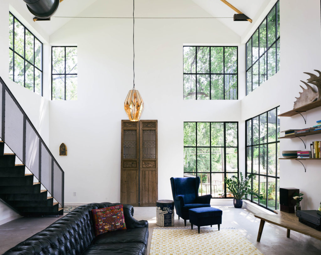 Cedar siding, exposed wood and steel framing, and steel windows imbibe the home with a hand wrought aesthetic, while trim-less details, large windows and clean unadorned lines pay respect to Modernism. (Photo by Amanda Kirkpatrick)