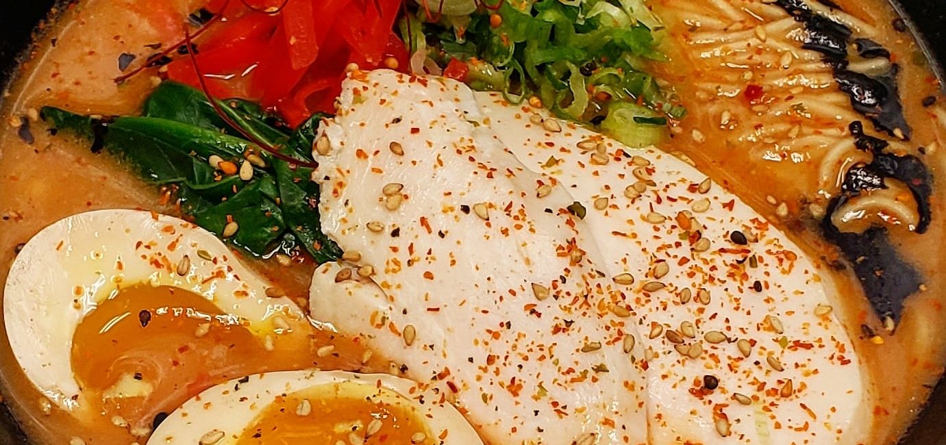 Kintaro Ramen – The Karashi Paitan is a spicy creamy chicken broth topped with a mayu schmaltz, muneniku, 6-minute egg, & pickled red ginge