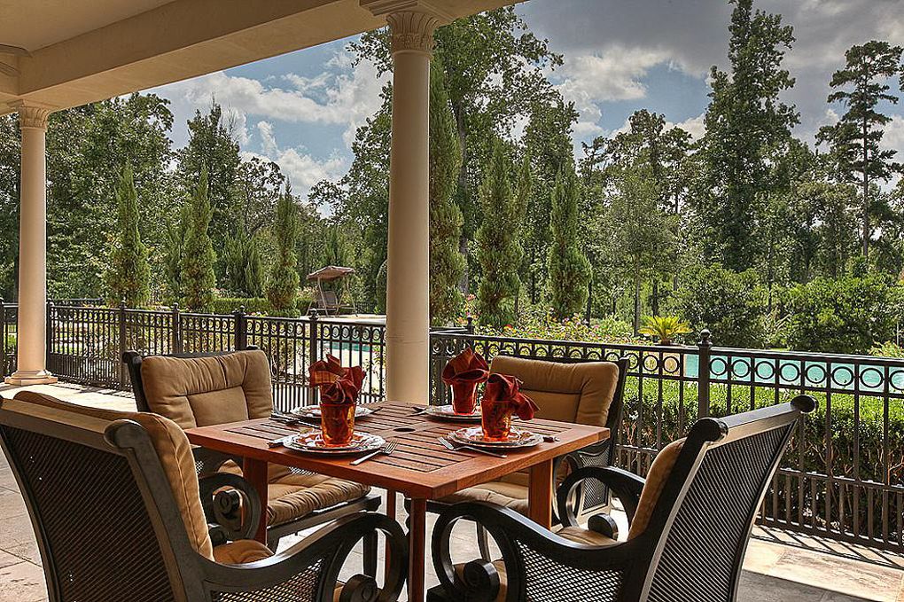 The massive mansion at 126 S. Tranquil Path in The Woodlands offers verdant views to the manicured grounds and the surrounding forest.