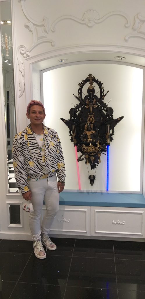 Artist Alex Ramos wears a black-and-white shirt showing his neutrality between the dark and light side. Ramos poses with "Dark Side of the Empire," 2015. (Photo by Catherine D. Anspon)