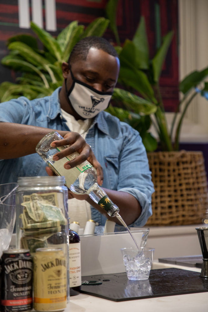 Bartender, Clif Taylor, was a popular man all night at the opening of "Collect It For the Culture III." (Photo by Nicole Electra)