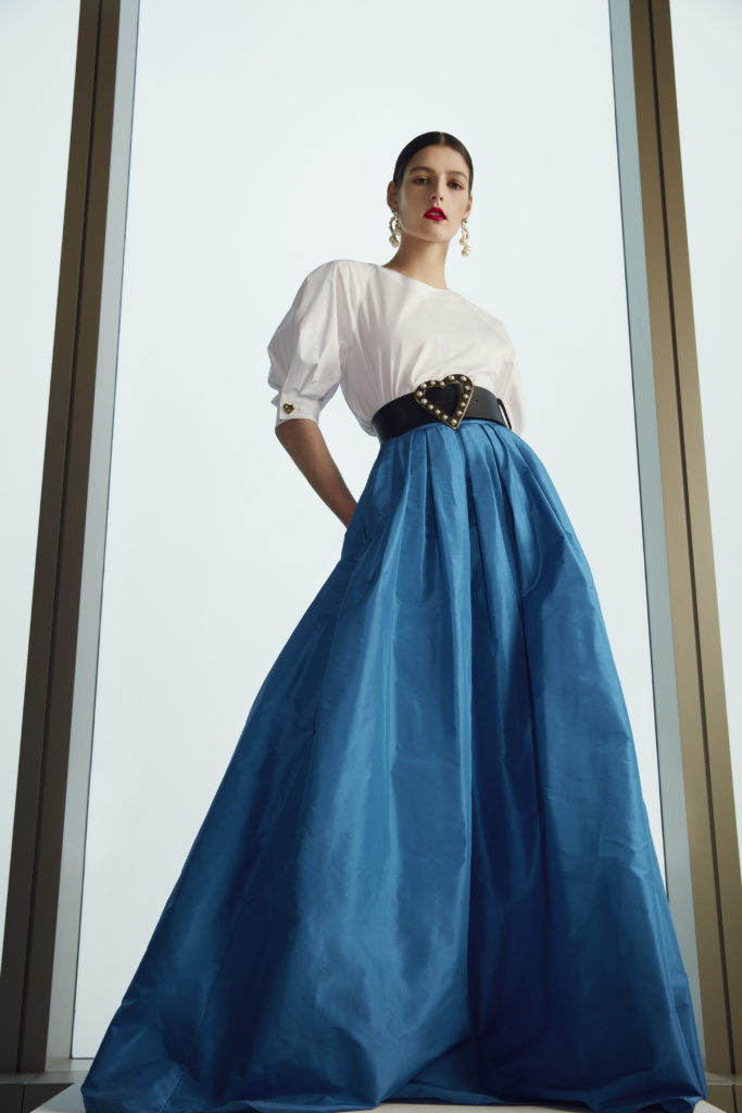 Classic Carolina Herrera white shirt, blue long skirt, black belt with heart buckle. (Photo courtesy of Carolina Herrera)