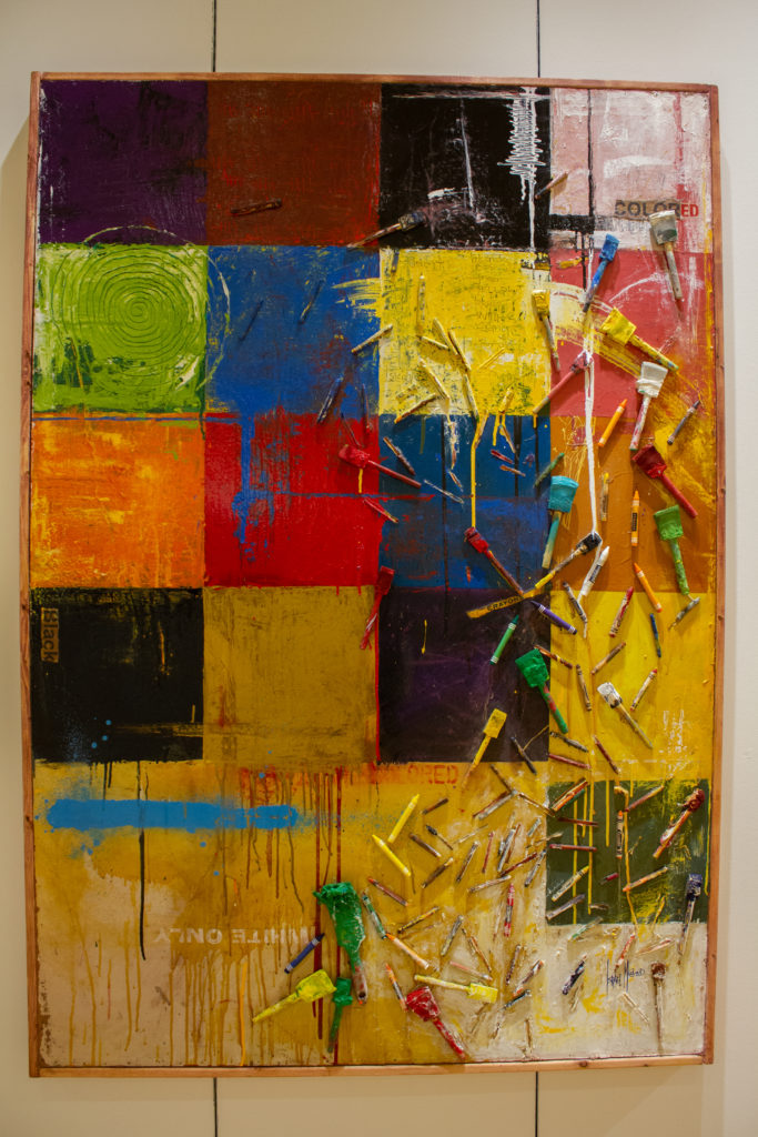 Crayons and paintbrushes on a colorful grid hide a more serious topic of race. Israel McCloud's "Some of My Best Friends Are Colored," 1994. (Photo by James Karroum)