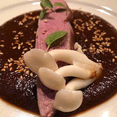 Over-the-top duck breast and pickled mushrooms, atop his mother Juanita’s famous mole sauce.