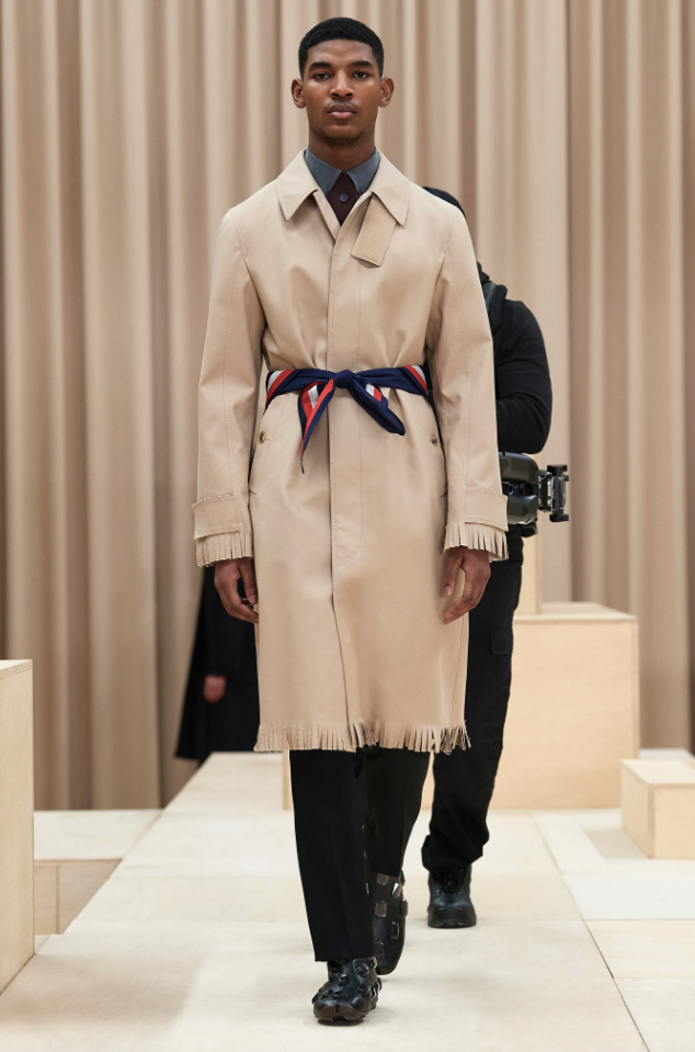 Burberry trench coat with fringe hem and silk scarf cinched at the waist. (Photo courtesy of Burberry)