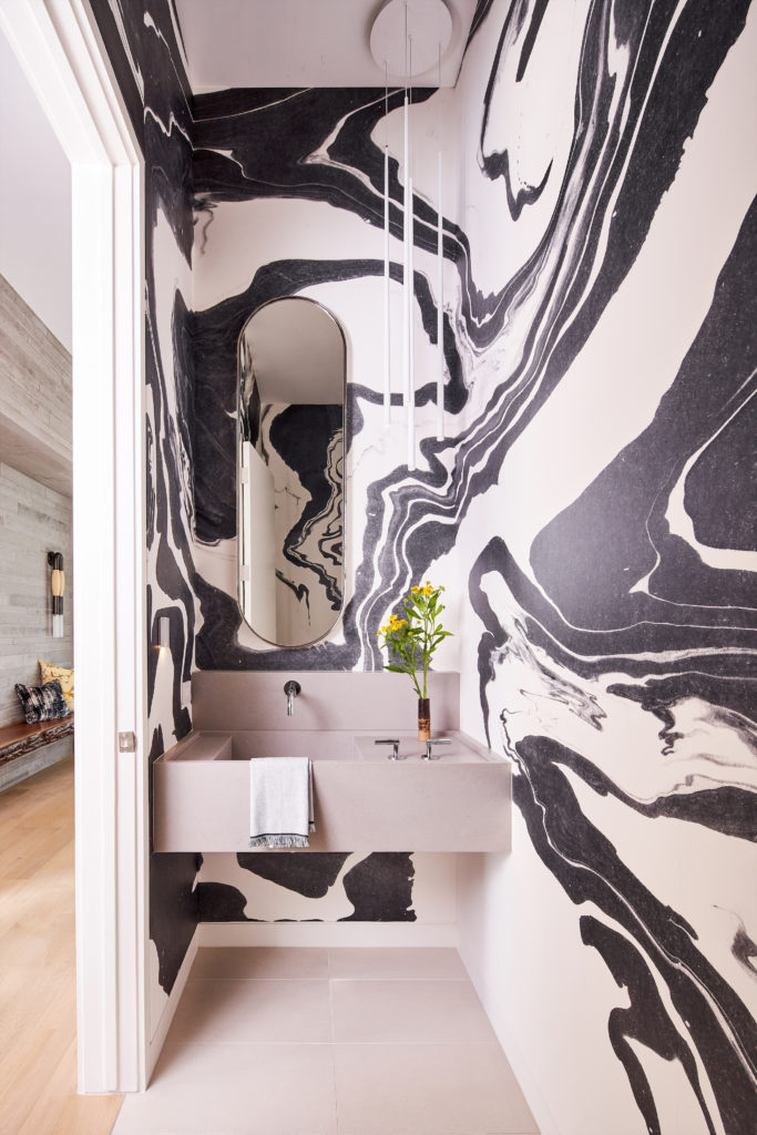The powder bath is covered in Calico wallpaper’s Sumi collection. Vibia pendants. Custom Caesarstone raw concrete sink, custom mirror by Jean Liu Design Studio and Randy Kienast. (Photo by Stephen Karlisch)