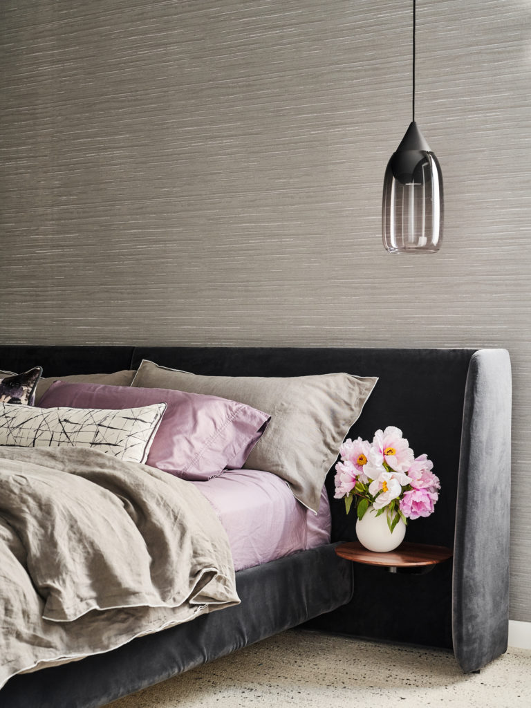 Blu Dot bed in a downstairs bedroom, with Parachute Home bedding. Liuku glass pendant, Zinc Textile wallpaper. Truett silk rug. (Photo by Stephen Karlisch)