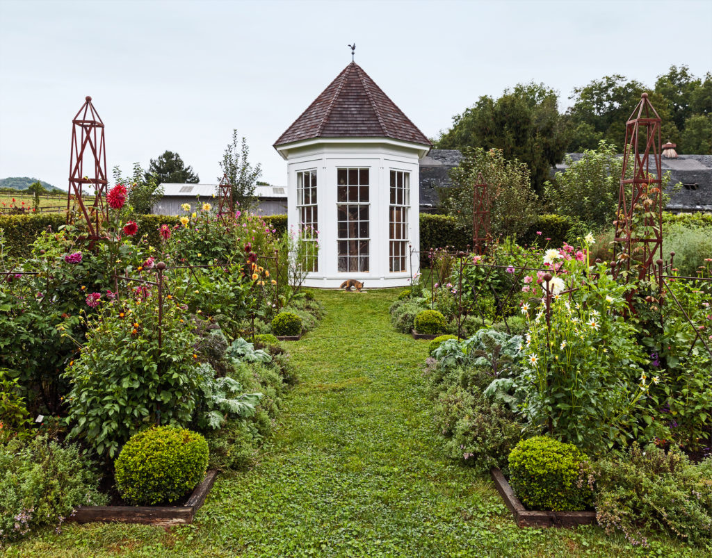 Christopher Spitzmiller hand-built the dovecote, which has a 10-foot-tall vintage window salvaged from a roadside sale. It houses a large family of Indian fantail pigeons.
