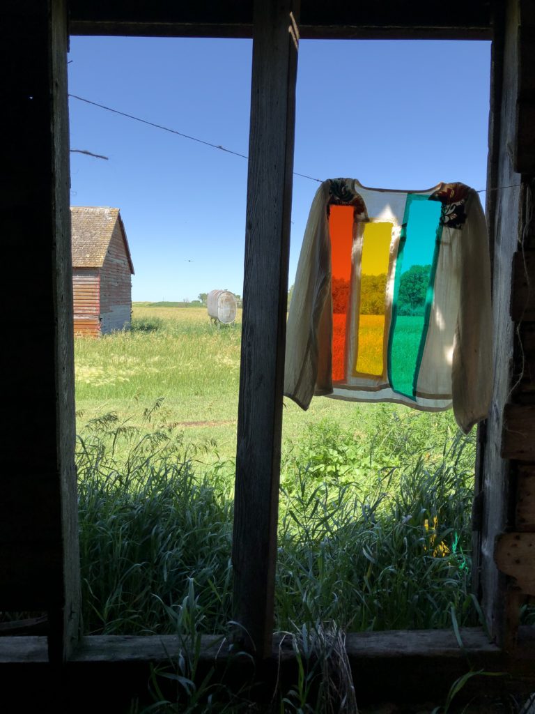 A garment-inspired handmade textile dialogues with a weathered South Dakota barn, summer 2020.