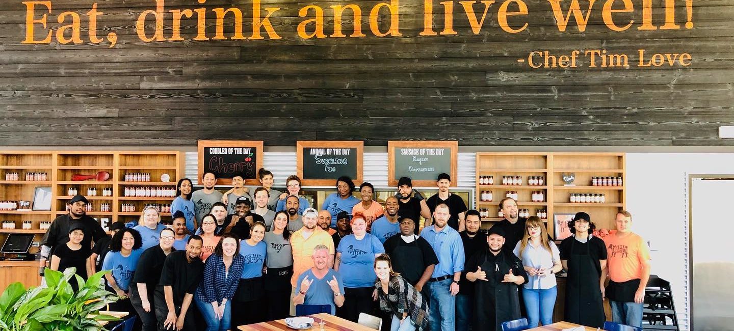 Chef Tim Love surrounded by staff in Houston