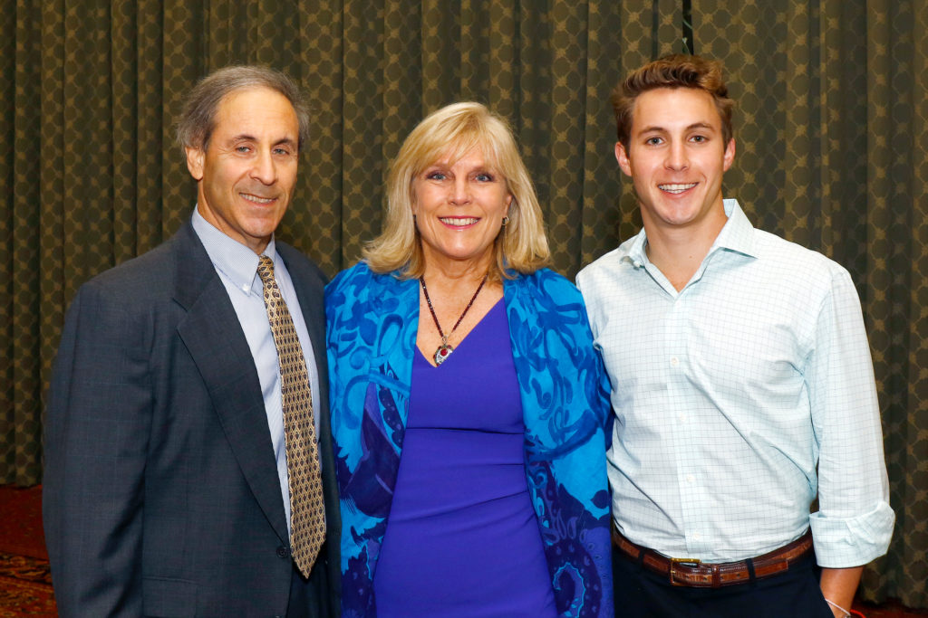 Flink wearing a Diane Von Furstenberg dress with husband Randy and one of her two sons. 