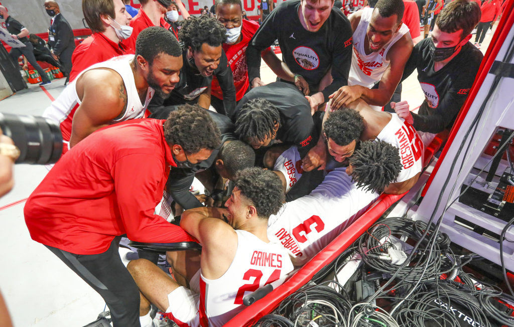 Tramon Mark got buried in a happy pile of joy after his buzzer beat brought the March magic to Houston early.  (@UHCougarMBK)
