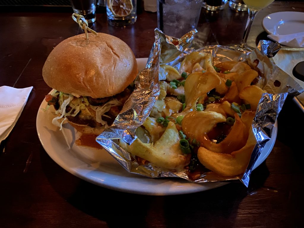 At Spider Murphy's, the 9-Layer burger includes a single patty, pork carnitas, bean and cheese tostada, and more. And with a side of Disco Fries, it's delicious. (Photo by Megan Ziots)