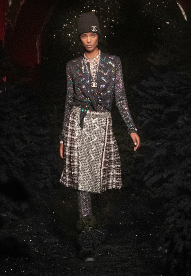 Chanel multi-tweed skirt and jacket, interlocking C beanie. (Photo courtesy of Chanel)