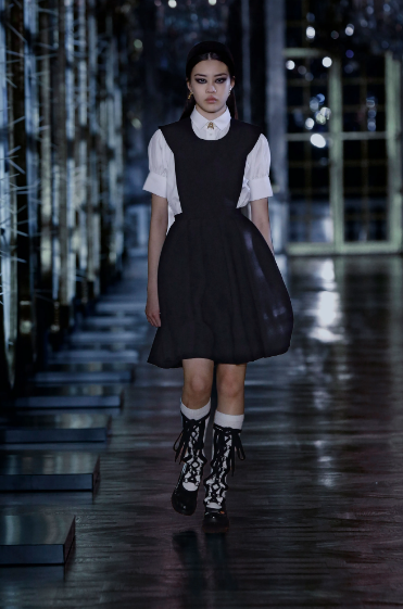 Christian Dior pinafore dress and lace-up boots. (Photo courtesy of Christian Dior)