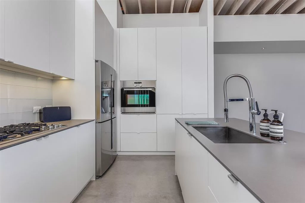 A clean-lined kitchen leads into the dining and leaving rooms. 