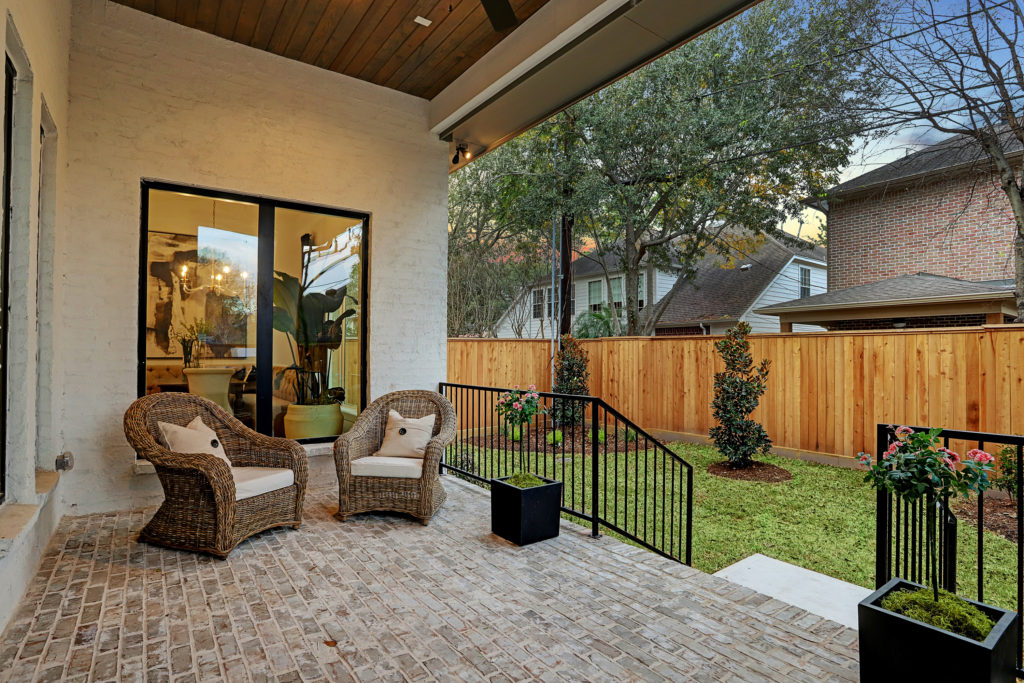 The covered patio and kitchen leads to lawn.