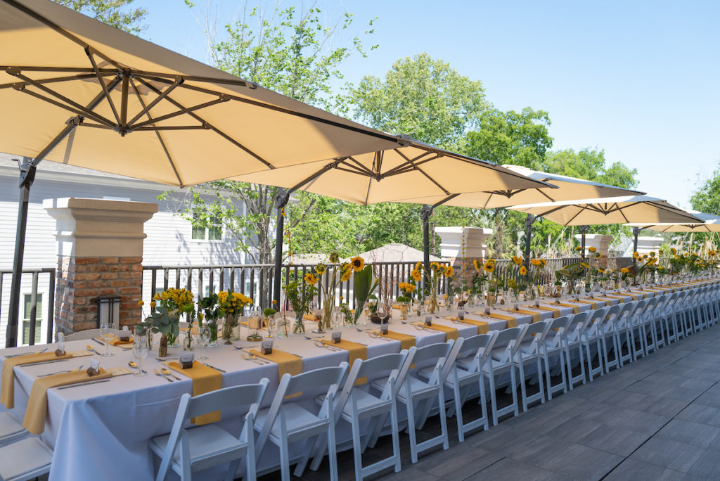 The table is set for 50-plus guests, 93 percent vaccinated, for Fady Armanious' birthday lunch on the rooftop terrace of Boulevard Realty offices. (Photo by Daniel Ortiz)