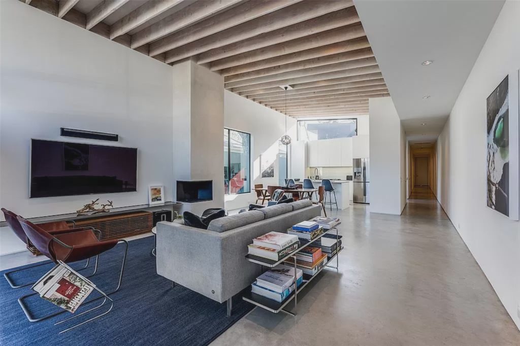 Vaulted wood beam ceilings add a beautiful touch to the versatile living area.